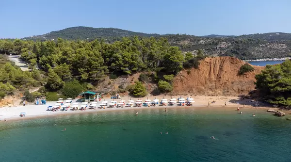 Aerial view of Kokkinokastro beach (Alonnisos) with its steep red slope at the back