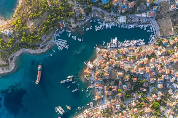 Aerial view of Mediterranean villas and ships in the port of the Saronic Island Spetses in the Argolic Gulf, Greece