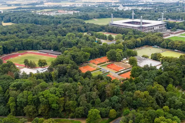 Aerial view of Park Linne with RheinEnergie stadium, tennis courts of KTHC Stadion Rot-Weiss and sports fields in Cologne, with Club Astoria in the back