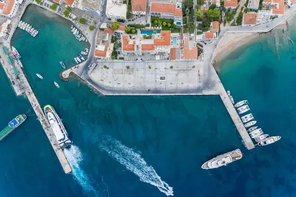 Aerial view of ships on a jetty and a water taxi stand in the blue sea