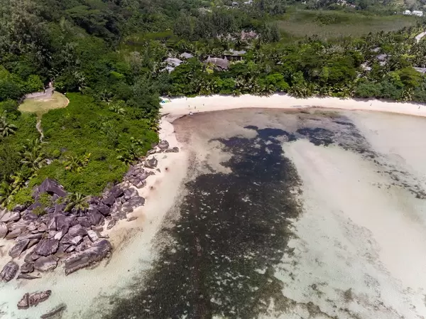 Aerial view of the granite stones and helipad at the coast of Port Glaud in Mahé in the Indian Ocean, Seychelles