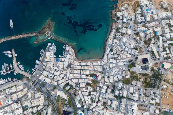 Aerial view of the port city Naoussa, in the northern part of the island Paros, with the remnants of a Venetian castle in the Mediterranean Sea