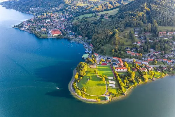 Aerial view of the Tegernsee lake in Bavaria with the town of Tegernsee, the Abbey and a large green area