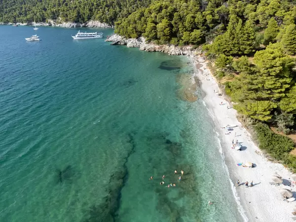 Aerial view of uncrowded Milia Beach on Skopelos: summer holiday 2021 on a Greek island