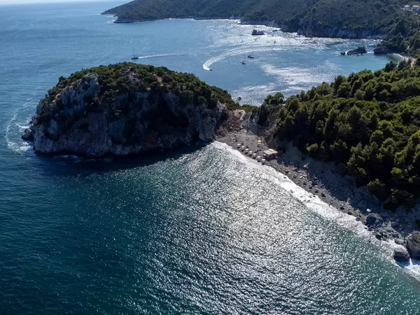 Aerial view of Velanio beach with silver sand and rocky headland on the Greek island of Skopelos