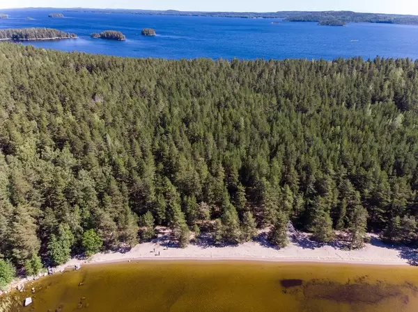 Aerial view shows different water colours and the island Kelvenne with its beach and bays at Lake Päijänne