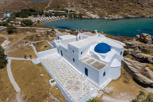 Aerial view shows Monastery of St. John's of Deti, in the valley of butterflies and nature park of Paros, Greece, with Monastiri Beach in the back