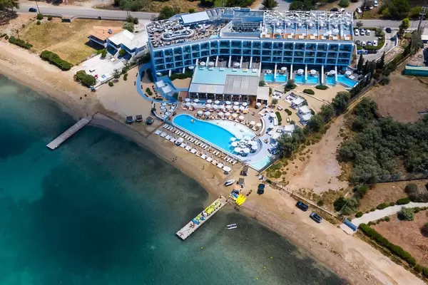 Aerial view shows the luxurious beach hotel Nikki Beach Resort & Spa, with rooftop bar, private swimming pool and direct access to the green sea