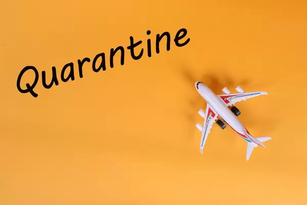 Airplane with Quarantine text on orange background