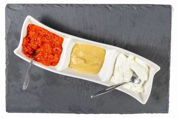 Ajvar Mustard and Tartar Sauce served on the black stone tray