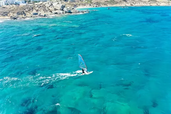 Aktiver Urlaub: ein Windsurfer vor der Küste bei Mikri Vigla auf Naxos, Griechenland. Luftaufnahme