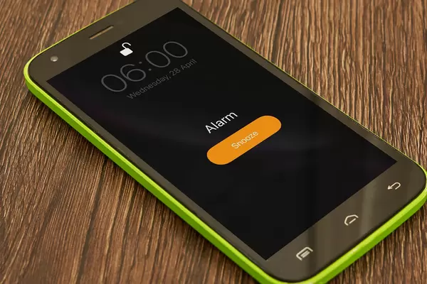Alarm clock on mobile phone rings at 6 am