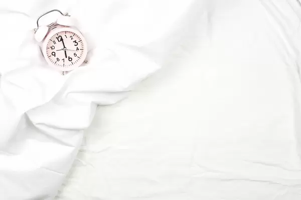 Alarm clock on the bed