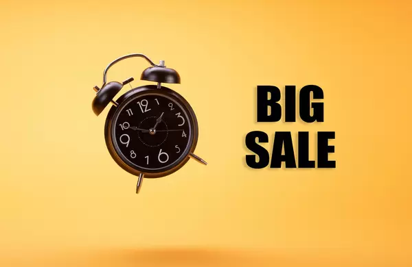 Alarm clock with Big Sale text on orange background