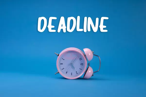Alarm clock with Deadline text on blue background