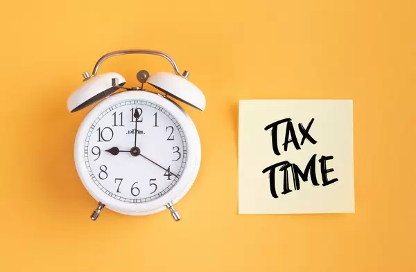 Alarm clock with handwritten text Tax Time