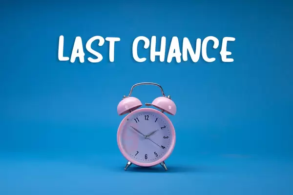 Alarm clock with Last Chance text on blue backgorund