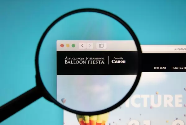 Albuquerque International Balloon Fiesta website with a magnifying glass
