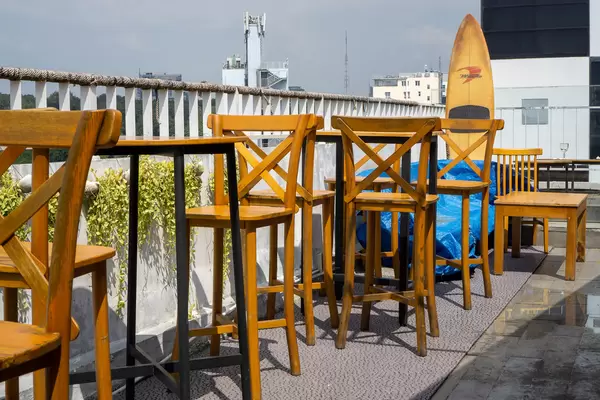 Aloha Poke & Beer Restaurant and Bar Outdoor Terrace with Wooden High Chairs and Tables in Ho Chi Minh City, Vietnam