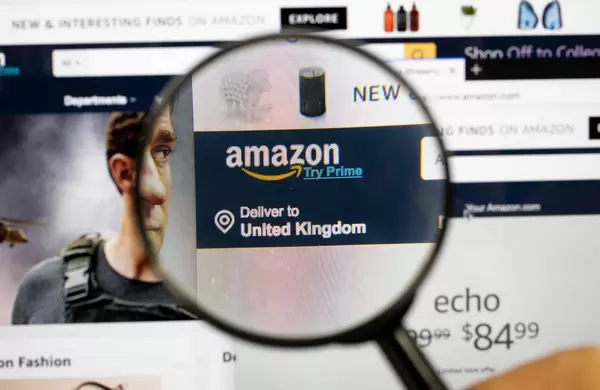 Amazon logo on a computer screen with a magnifying glass