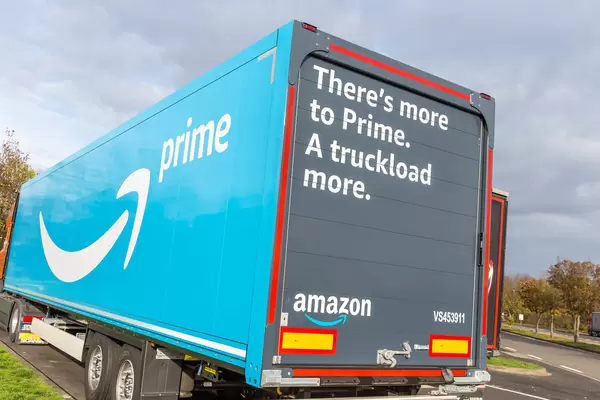 Amazon Prime Truck with Words 'There's more to Prime. A truckload more.' printed on it parking at a Rest Stop in Germany