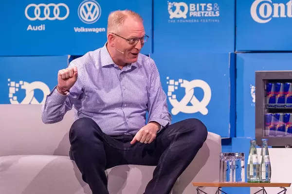 Amazon's Dave Limp interacts with the interviewer on the stage of the start-up and innovation event Bits & Pretzels in Munich