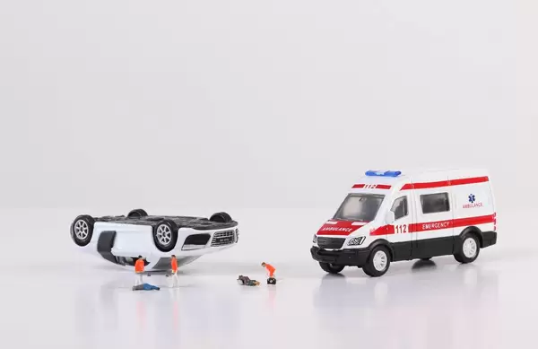 Ambulance car, paramedics and crashed car on white background