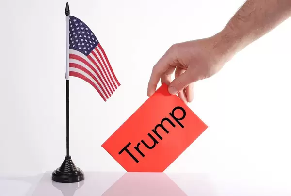 American flag and envelope with Trump text