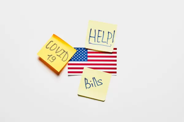 American flag and notes with Help, Covid-19 and bills texts