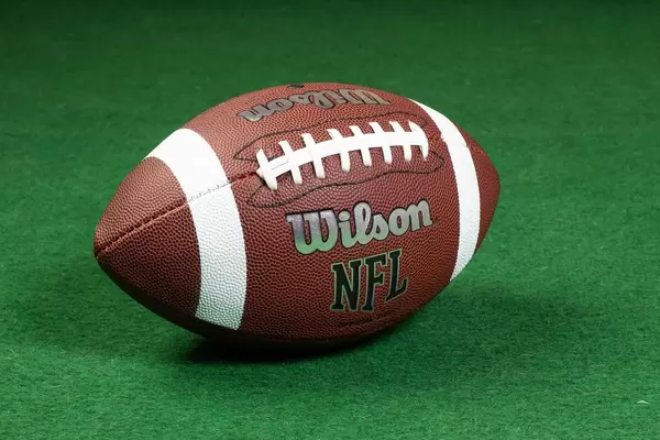 American football ball on grass