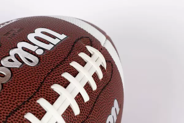 American football ball on white background