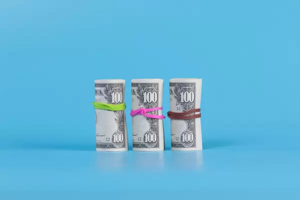 American US dollar bills in rolls on blue background