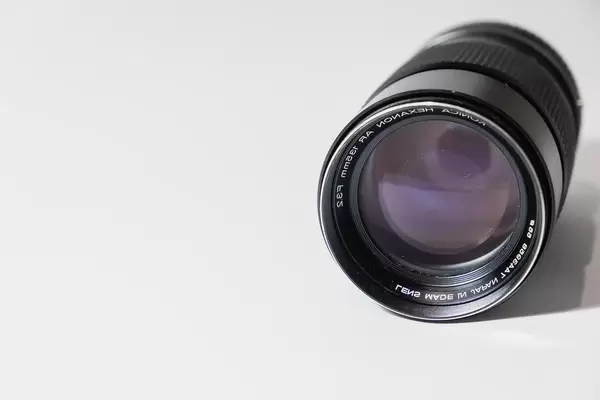 An old dusty camera lens on white surface (Flip 2019)