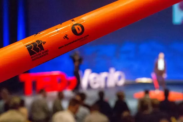An orange Boomwhacker instrument at the TEDxVenlo 2018