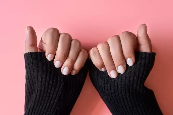 An unrecognizable female showing her hands with beautiful nail manicure.jpg