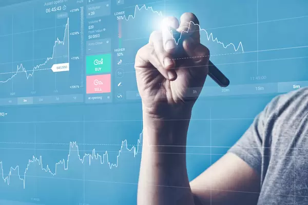 Analyst viewing financial stock market data on the holographic screen