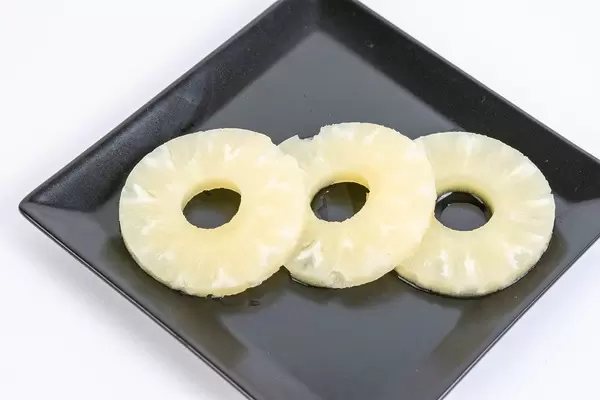 Ananas Compote arranged and served on the black plate