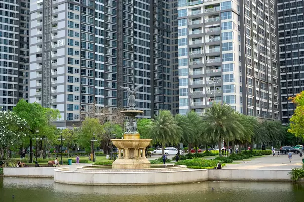 Angel Statue on a Large Fountain in front of Vinhomes Central Park with Apartment Buildings and Palm Trees in the Background in Ho Chi Minh City, Vietnam