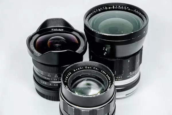 Another shot of old vintage lenses on white background
