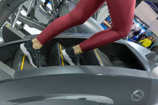 AnyFit step machine used by training woman at Fibo Cologne