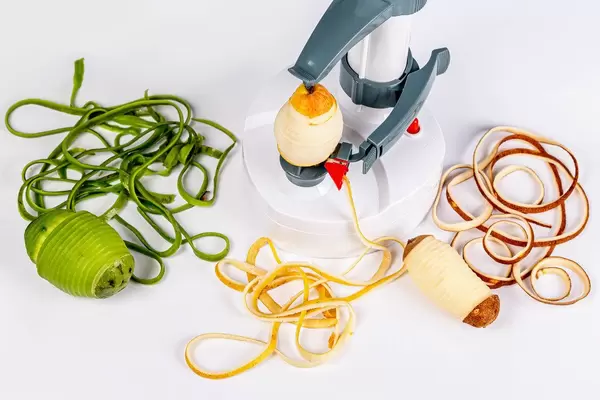 Apparatus for purifying peel with fresh fruits and vegetables on a white background