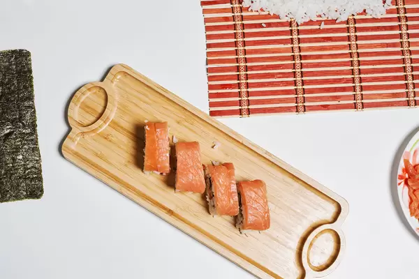 Appetizing sushi rolls on a wooden plate