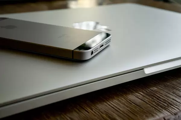Apple iPhone and MacBook on a Wooden Table with Reflection  Flip 2019