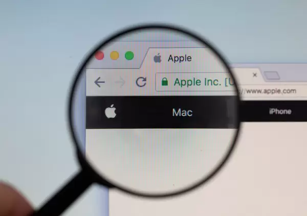 Apple logo on a computer screen with a magnifying glass