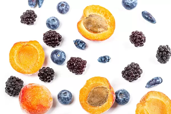 Apricot, blackberry, honeysuckle and blueberry on white