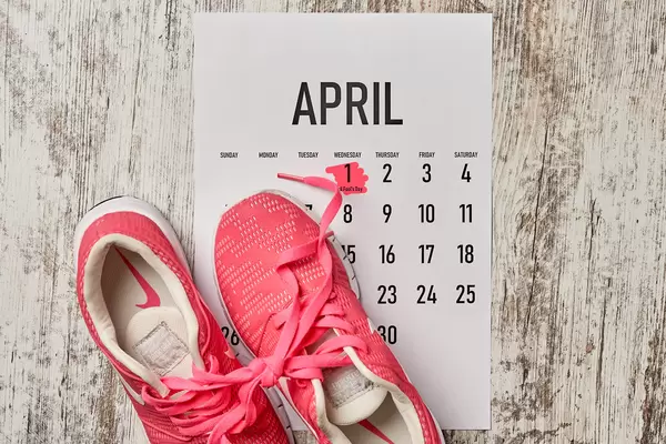 April fool's day - shoelaces tied together on wooden background