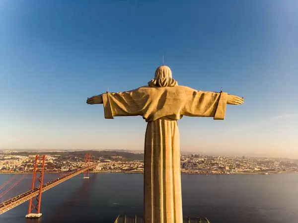 Areal view / drone shot of the Cristo rei monument from behind in Almada Lisbon