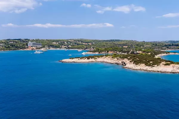 Areal view from the sea to Chenesar Island and Aks Hinitsa Bay Hotel in Chinitsa, Greece