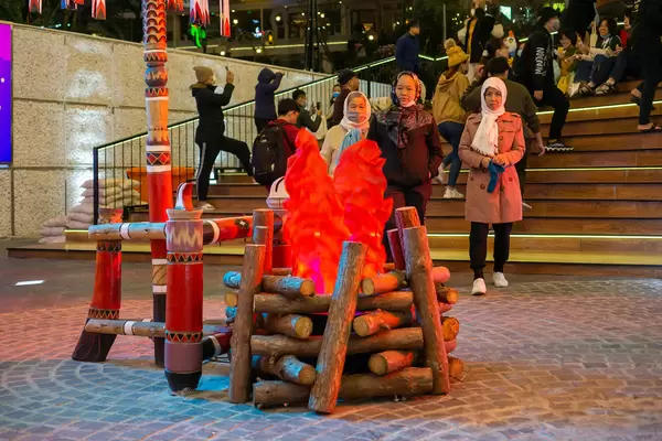 Artificial Campfire in the Middle of a Square with People around it at the Night Market in Dalat, Vietnam