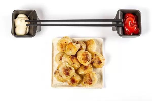 Asian food concept, fried dumplings with red and white sauces
